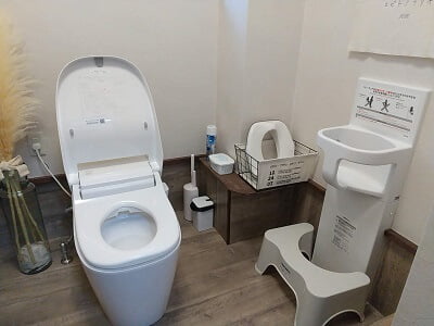 Guu diner/コビトノフクヤの広いトイレの大人用トイレ近くの壁にベビーチェアがある